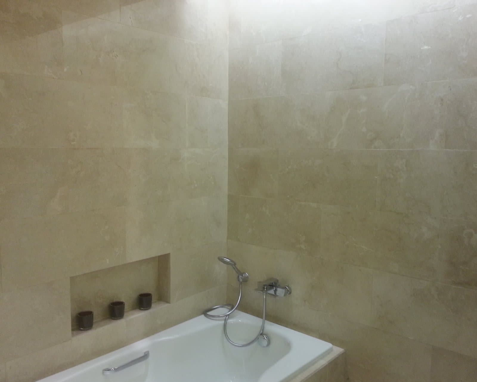 Bathroom fully clad in cream marble