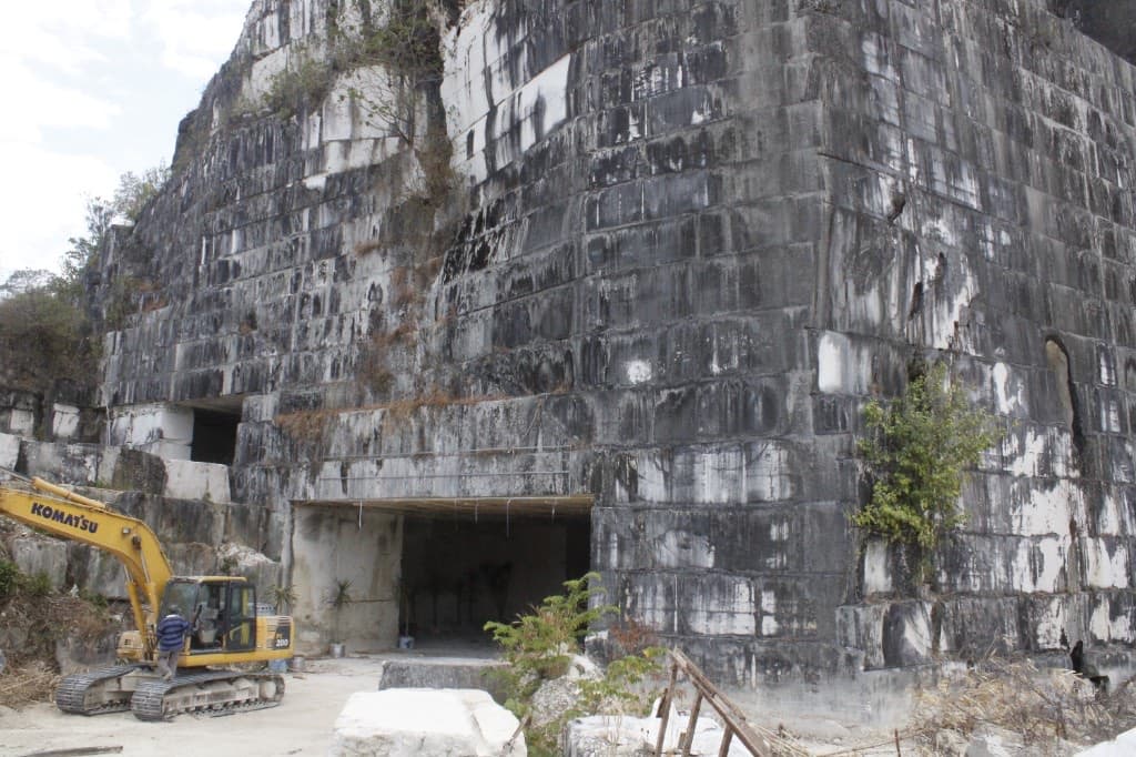 Active quarry face and excavator at RadjaGunungMarmer
