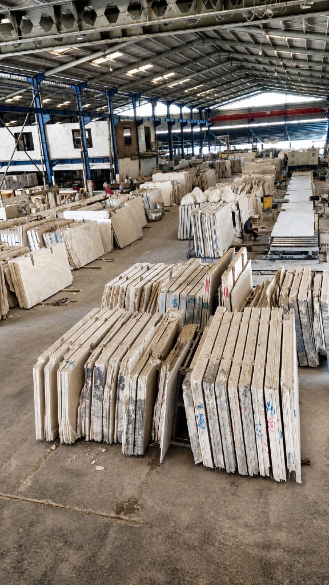 Rows of finished marble slabs staged for dispatch in the RadjaGunungMarmer processing hall